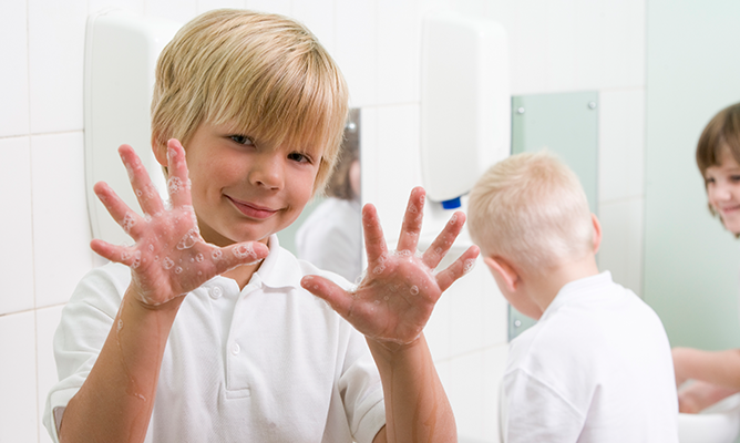 School child washing hands
